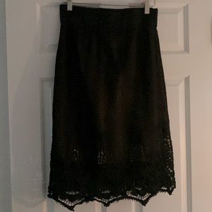 Tan skirt under a black lace overlay